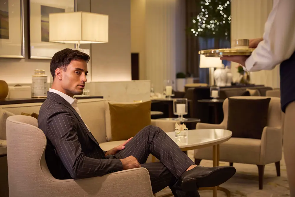 A guest seated in the lobby lounge at Address Downtown