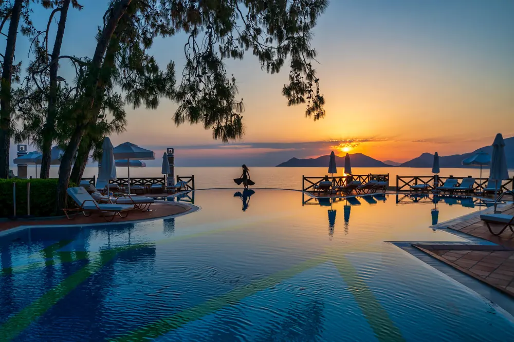 The infinity pool at Liberty Lykia at sunset, level with the Mediterranean beyond it