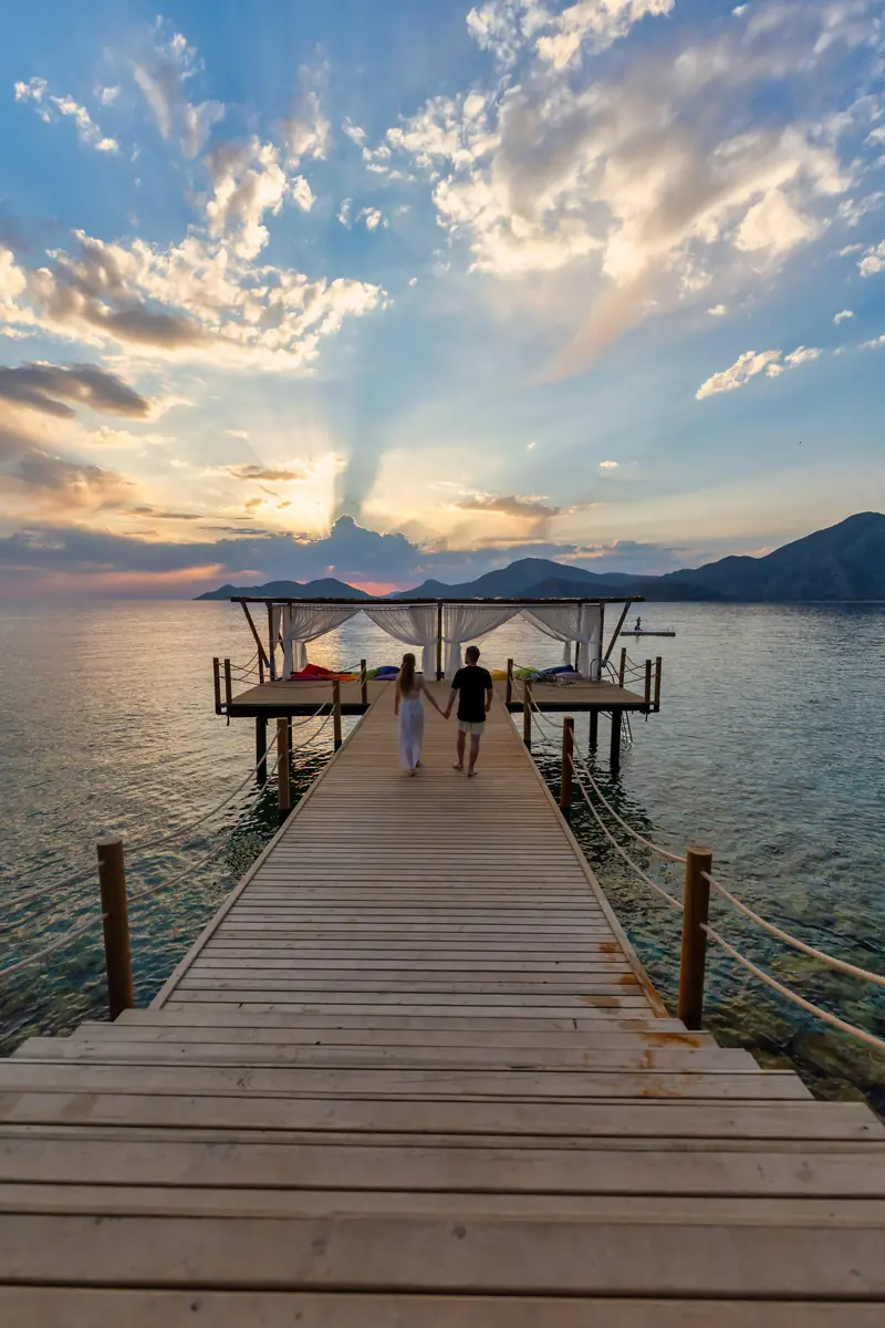 Guests walking the wooden jetty at Liberty Lykia as the light goes