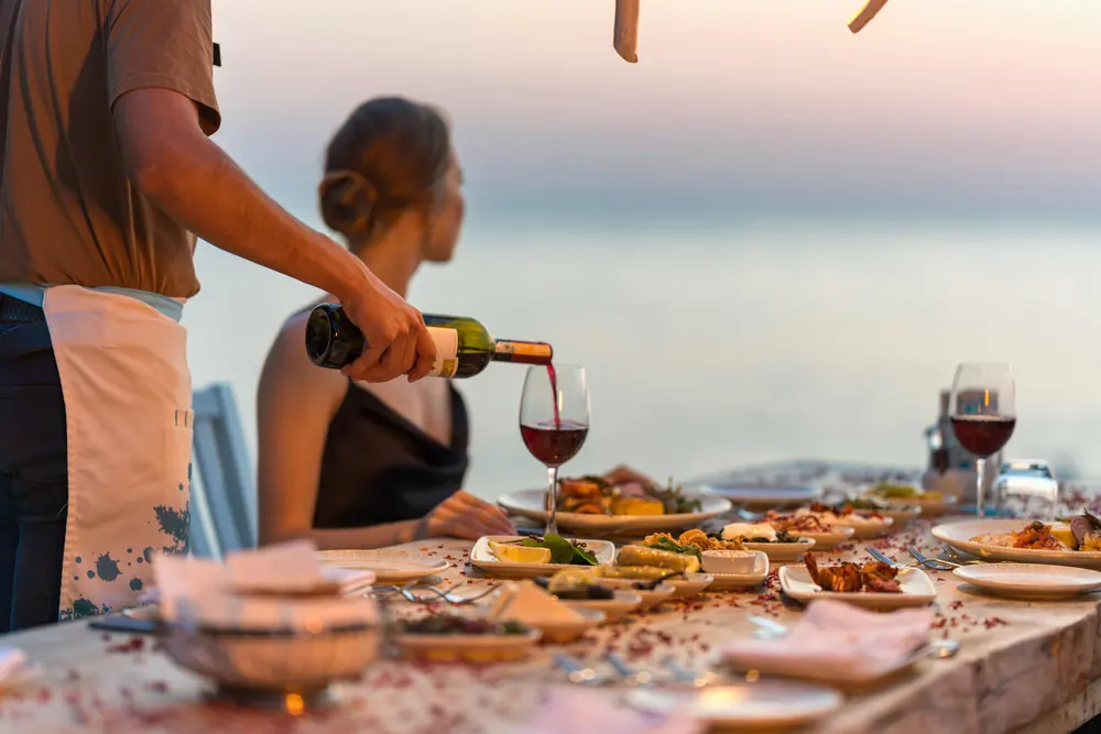 Wine poured at the seafront dining table at Liberty Lykia