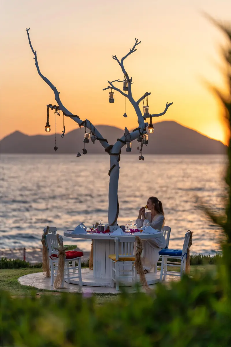 The lantern tree table at Liberty Lykia set for dinner as the sun drops