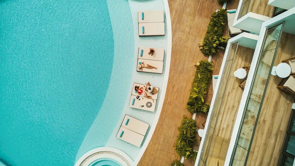 Daybeds and parasols around the pool at Radisson Collection Galle, looking straight down