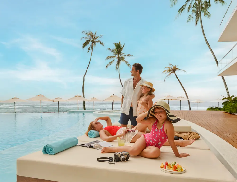 A family on the poolside daybeds at Radisson Collection Resort & Spa, Galle
