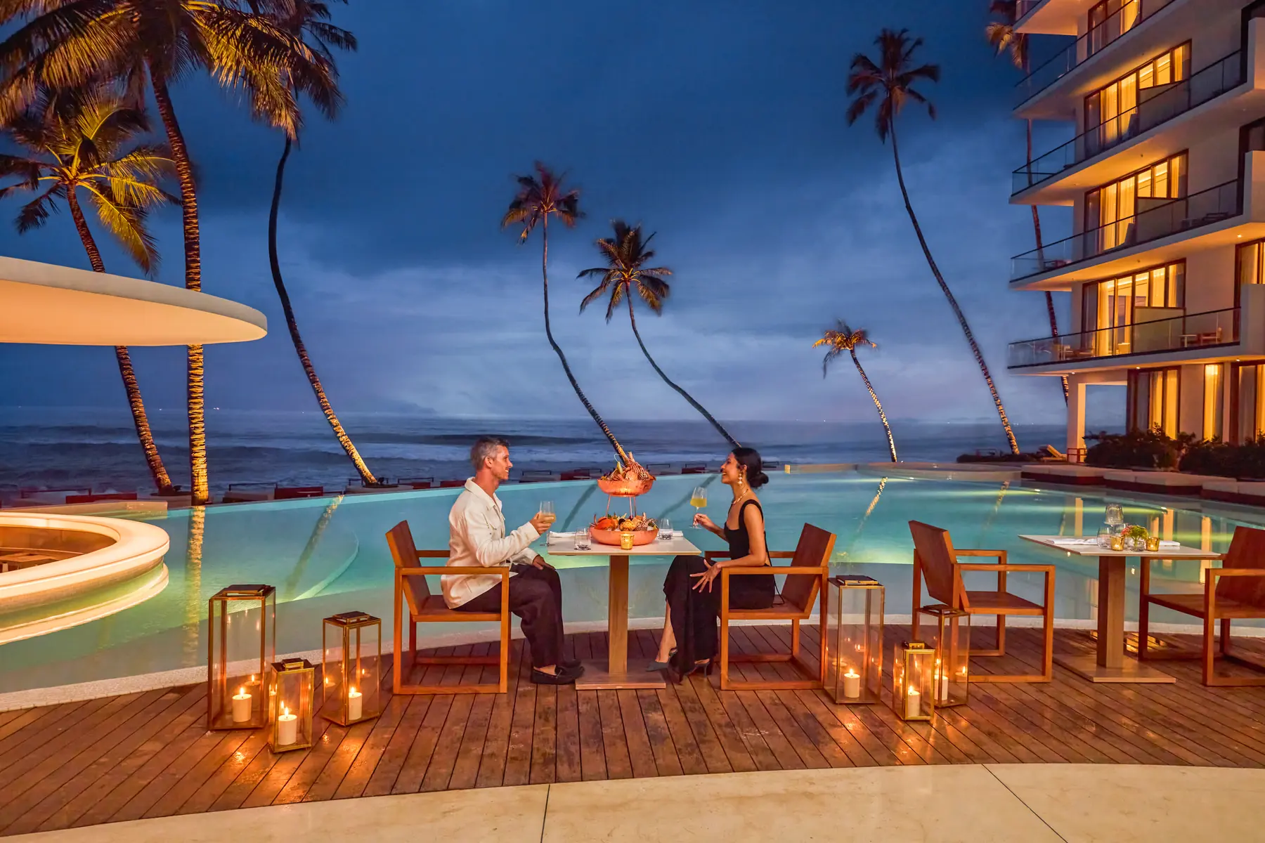 Radisson Collection Resort & Spa, Galle lit at dusk, with poolside dining beneath the palms